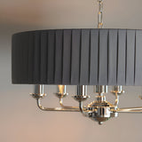 Brenley V1 6 Light Pendant in nickel and chrome, close-up of pleated grey fabric drum shade above chrome candle-style arms and chain suspension.