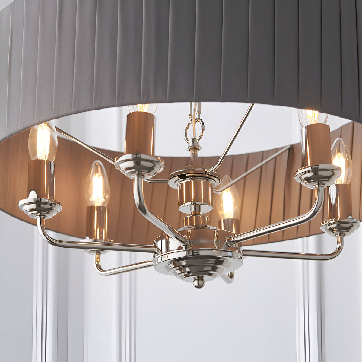 Brenley V1 six-light pendant with nickel and chrome arms, exposed bulbs, and a grey fabric drum shade with reflective metallic lining.
