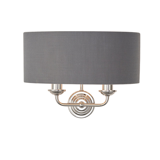 Brenley 2 Light Wall Light in nickel with a grey fabric drum shade and twin curved arms, shown on a plain white background.