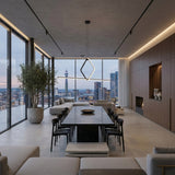 A modern high-rise apartment features a spacious dining and living area with floor-to-ceiling windows, city views, minimal decor, a large dining table in neutral tones, and the Minimo LED Bar Square Linear Suspension Light in black.