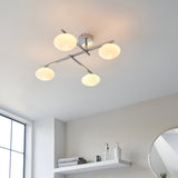 Denby 4 Light Semi-Flush Bathroom Ceiling Light in chrome, with crossed arms and four opal glass shades, shown on a white ceiling above a bathroom shelf.