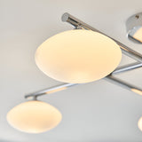 Denby 4 Light Semi-Flush Bathroom Ceiling Light in chrome, close-up of oval opal glass shades on angled chrome arms against a light ceiling.