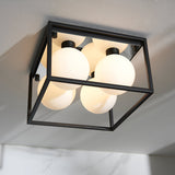 Endon Sable 4 light semi-flush bathroom ceiling light with matt black square cage frame and four opal glass globes, mounted on a white ceiling.