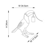 Cranmont Toucan Table Lamp in gold resin with line-art style illustration showing dimensions, black E27 bulb holder, and hanging cord detail.