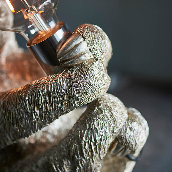 Close-up of Endon Cliffmont table lamp showing the vintage silver resin sloth's detailed fur and paws gripping the chrome E27 lamp holder.