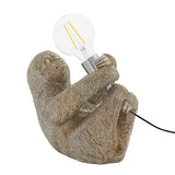 Endon Cliffmont table lamp with a vintage silver resin sloth holding a chrome E27 holder and exposed globe bulb, on a white background.