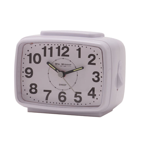 Oblong white plastic alarm clock with sweep movement, featuring a white dial, bold black Arabic numerals, and black hands, shown against a plain background.
