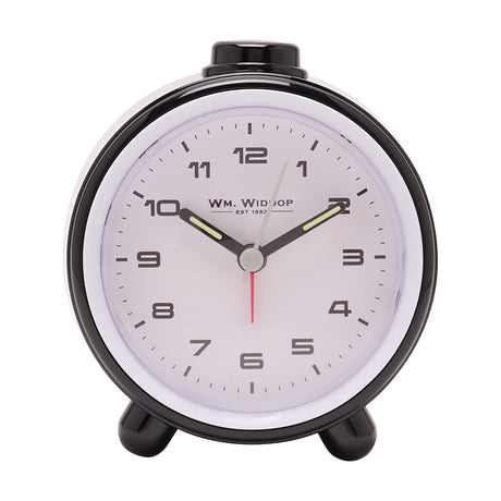 Round alarm clock with glossy black plastic case and white bezel, white dial with bold Arabic numerals, black hands and red second hand, set on two black feet against a plain white background.