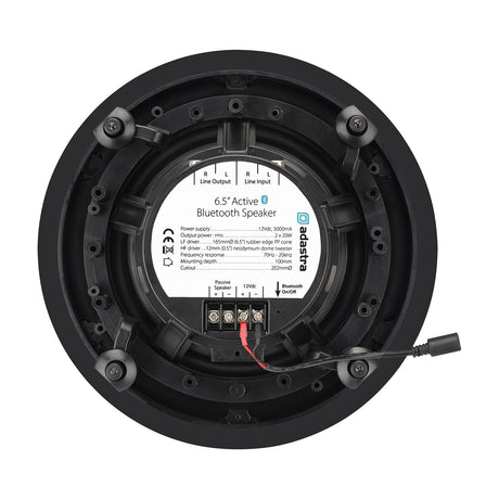 Rear view of Adastra BCS65S 6.5in ceiling speaker showing black driver, mounting clips, terminal block, RCA line in/out labels and Bluetooth on/off button.