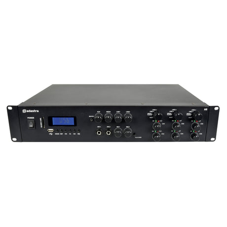 The image displays an Adastra A6 Tri Stereo Amplifier in black, featuring stereo outputs and numerous control knobs, complemented by a digital display on the front panel. It includes various input ports and a power switch on the left side, showcasing the versatility of multi-zone amplifiers for an enhanced media player experience.