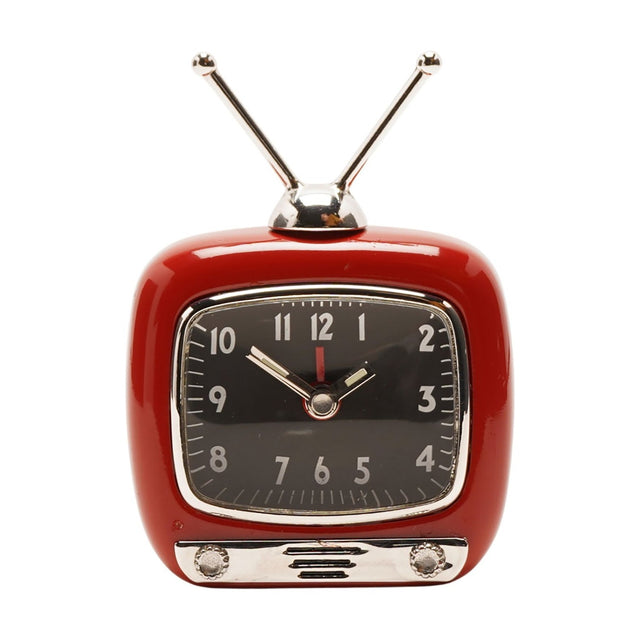 Red miniature television-style alarm clock with silver dome, twin aerials, chrome bezel, black dial with silver numerals and hands, and silver base panel with two knobs, on white background.