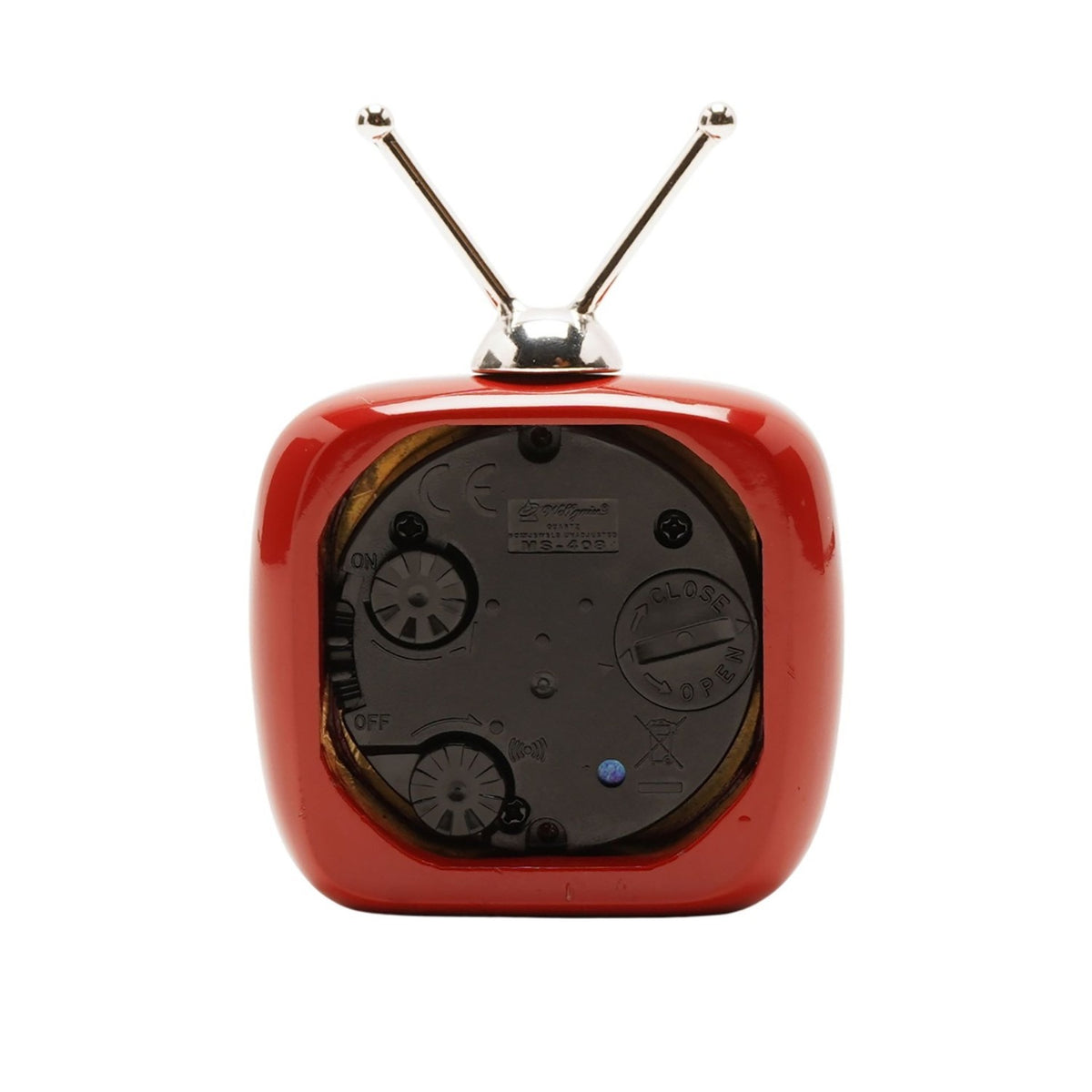 Rear view of the Miniature Television Alarm Clock with Twin Aerials in red, showing silver antennae, battery compartment, and control dials on a white background.