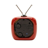 Rear view of the Miniature Television Alarm Clock with Twin Aerials in red, showing silver antennae, battery compartment, and control dials on a white background.