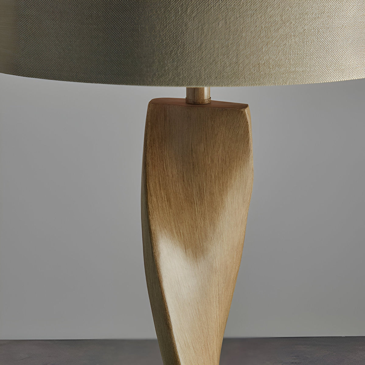 Close-up of the Endon Alcott floor lamp base showing the spiralling light oak effect wood column beneath a natural linen cylinder shade.
