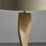 Close-up of the Endon Alcott floor lamp base showing the spiralling light oak effect wood column beneath a natural linen cylinder shade.