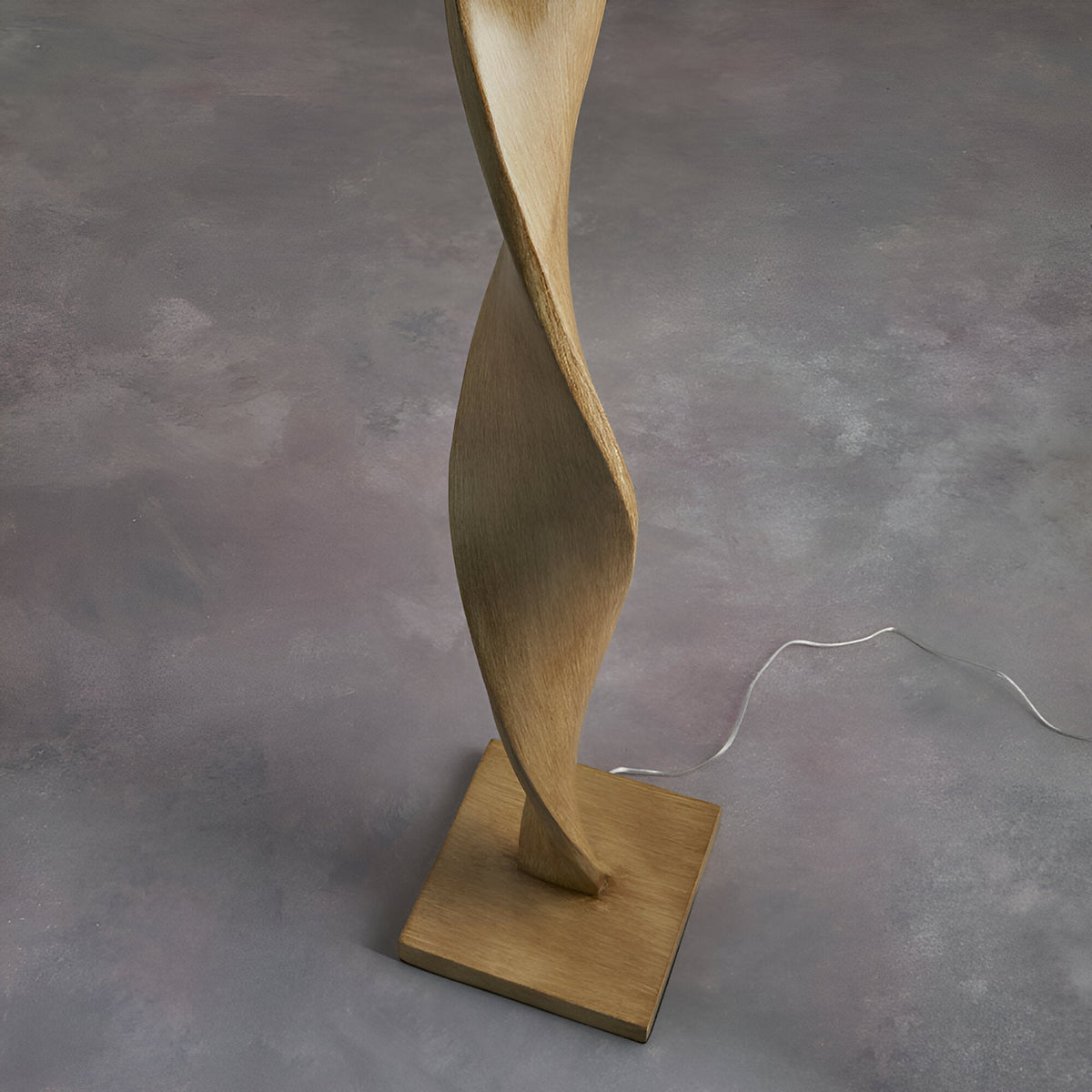 Endon Alcott floor lamp base detail showing the light oak effect spiral wood column on a square plinth against a grey floor.