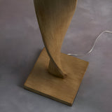 Endon Alcott floor lamp base detail showing the spiralling light oak effect wood column set on a square plinth, with black cable trailing across grey flooring.