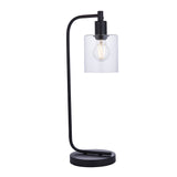 Endon Cranmere table lamp in matt black with an arched metal stand, clear glass cylinder shade and exposed filament bulb, on a plain white background.