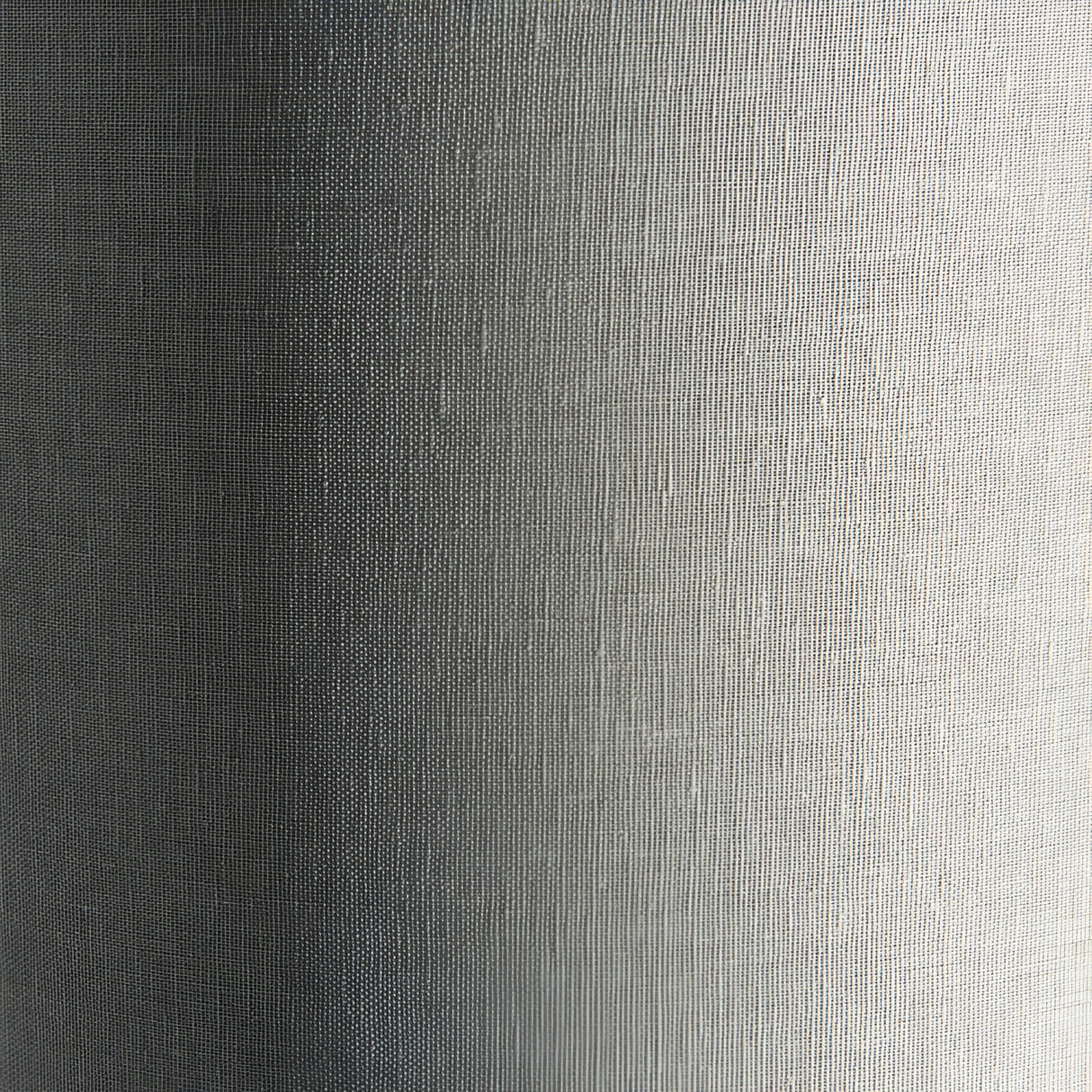 Close-up of the Endon Bramdon floor lamp's natural mixed-linen cylinder shade, showing the woven fabric texture in soft light and shadow.