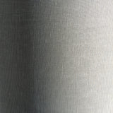 Close-up of the Endon Bramdon floor lamp's natural mixed-linen cylinder shade, showing the woven fabric texture in soft light and shadow.