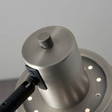 Close-up of the Endon Carlbourne floor lamp head in brushed silver with matt black bracket, showing knurled rotary switch and vent holes.