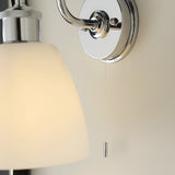 Chartdon Bathroom Wall Light in polished chrome, showing the swan-neck arm, round wall plate, opal glass shade edge, and pull-cord switch with pull chain.