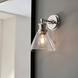 Endon Cranmore bathroom wall light in polished chrome with a cone-shaped clear glass shade, pull cord switch, and knurled circular back plate.