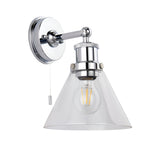 Endon Cranmore bathroom wall light in polished chrome with cone-shaped clear glass shade, knurled circular back plate, pull cord switch, and E27 filament bulb.