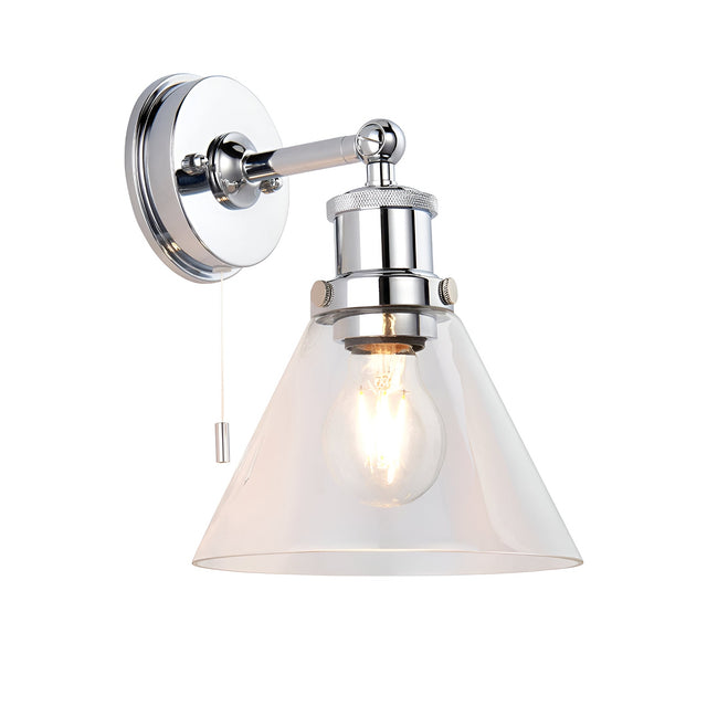 Endon Cranmore bathroom wall light in polished chrome with cone-shaped clear glass shade, E27 bulb and pull cord switch, on a plain white background.