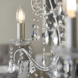 Close-up of Endon Aldwood 3 light pendant showing lit E14 candle bulb, faceted crystal droplets and beaded strands on aged silver metalwork.