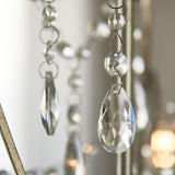 Close-up of Endon Aldwood 3 Light Pendant in silver, showing clear faceted crystal teardrop and octagonal droplets linked by beaded chains on aged metalwork.