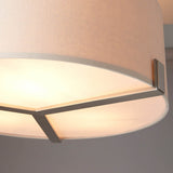 Close-up of Endon Brendon 3 Light Pendant showing the pale grey fabric drum shade, internal white diffuser, and brushed nickel bracket detail.
