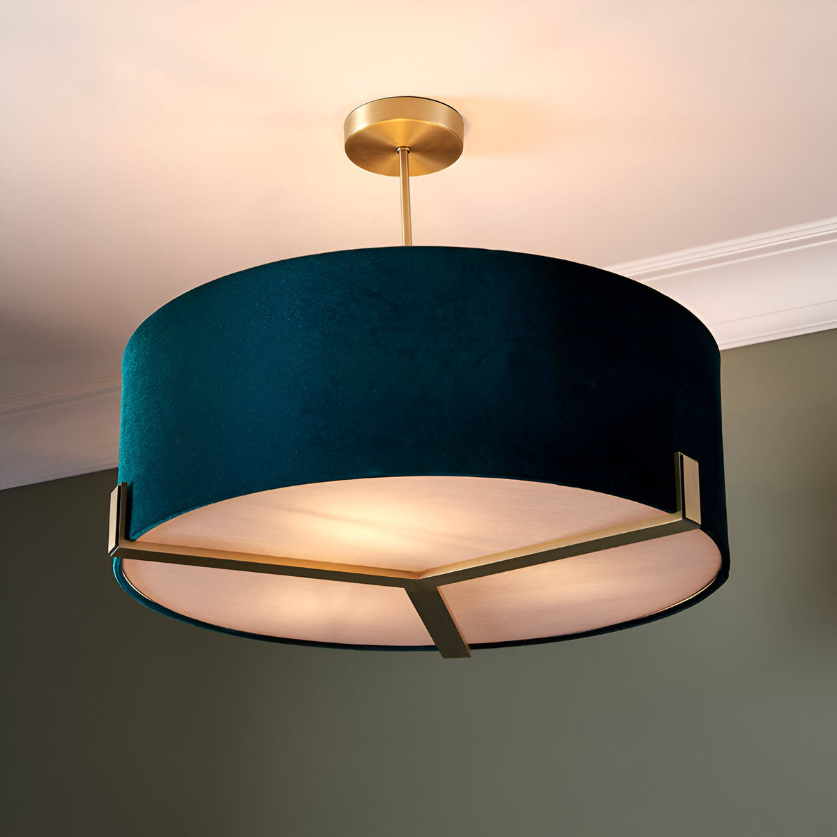 Brendon 3 Light Pendant with green fabric drum shade, brass fittings and white diffuser, hung from a telescopic brass stem in a room setting.