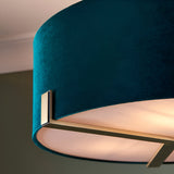 Close-up of the Brendon 3 Light Pendant showing the teal fabric drum shade with white diffuser and a brushed brass bracket detail.