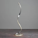 Endon Neve LED floor lamp with a tall spiralling silver leaf ribbon and illuminated white diffuser on a round base, shown against a plain grey backdrop.