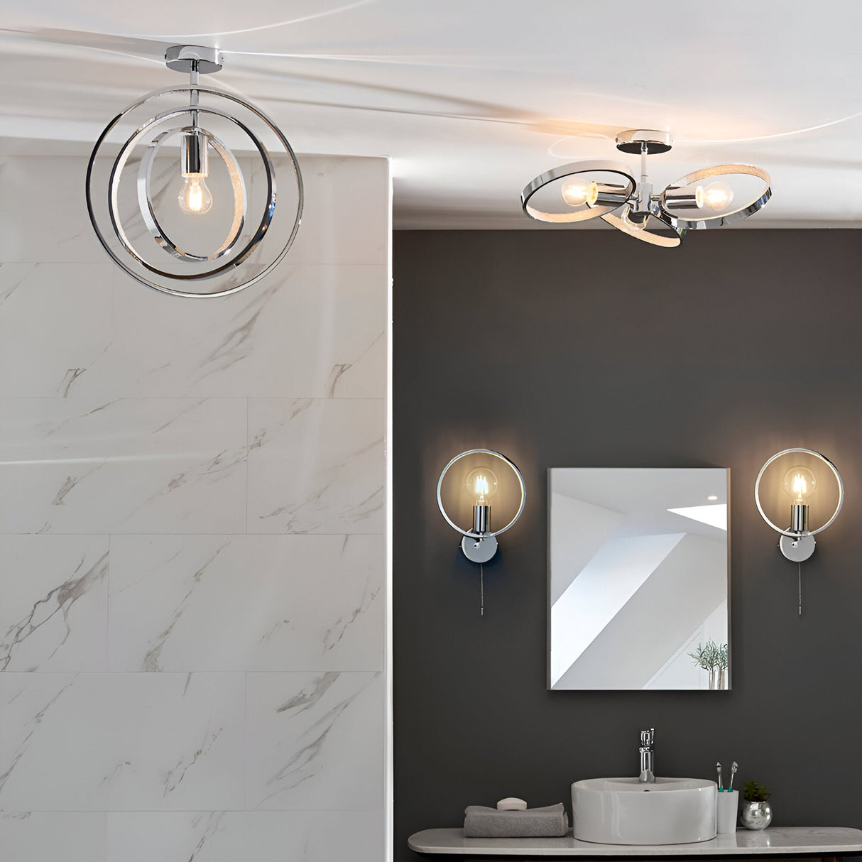 Endon Carlcombe chrome bathroom wall lights with faceted rings flank a square mirror above a basin, with matching ceiling fittings in a modern bathroom.