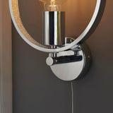 Close-up of Endon Carlcombe chrome bathroom wall light showing the polished circular backplate, pull cord switch, E27 lamp holder and faceted ring detail.