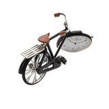 Black miniature pedal bike mantel clock with silver spokes, handlebars and pedal cranks, brown saddle and grips, and a white Arabic numeral dial set into the front wheel.