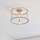 Endon Ellery flush ceiling light in brushed nickel with a drum-shaped glass shade and single E27 lamp, mounted on a white ceiling in a corner.