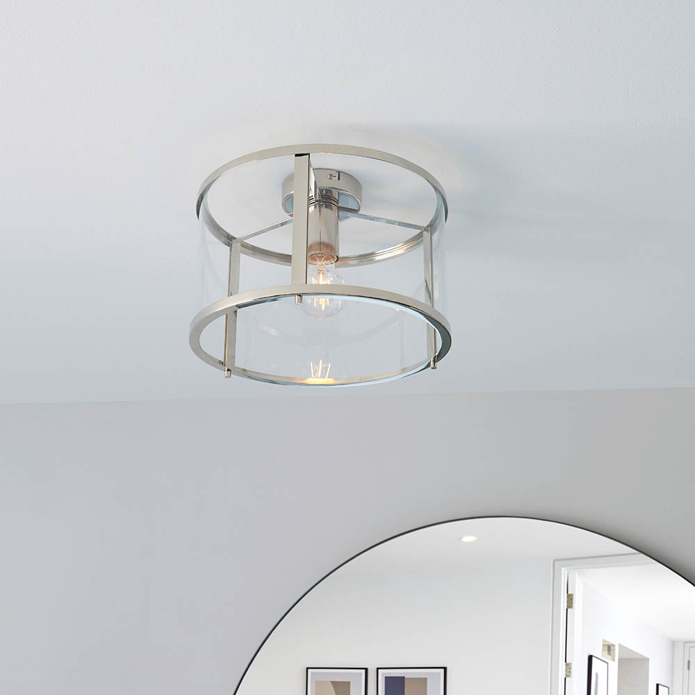 Endon Ellery flush ceiling light in brushed nickel, a single E27 drum fitting with clear glass shade and metal frame, mounted on a white ceiling.