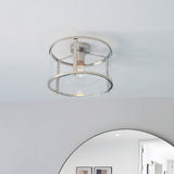 Endon Ellery flush ceiling light in brushed nickel, a single E27 drum fitting with clear glass shade and metal frame, mounted on a white ceiling.