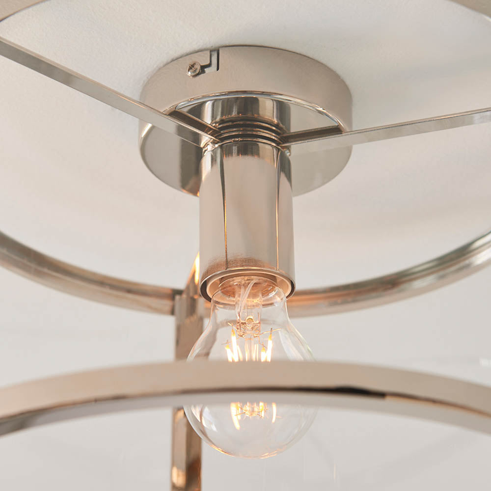 Close-up of the Endon Ellery flush ceiling light in brushed nickel, showing the E27 lamp holder, exposed bulb and curved metal frame supporting the shade.
