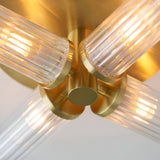 Close-up of Endon Wren 4 Light Semi-Flush Bathroom Ceiling Light in brass, showing four ribbed glass shades on angled arms around a central brass fitting.