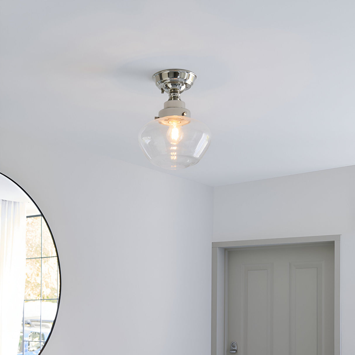 Endon Kedleston semi-flush ceiling light in nickel with clear glass shade, mounted on a white hallway ceiling near a round mirror and panelled door.