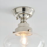 Endon Kedleston semi-flush ceiling light in nickel with a clear glass shade and exposed E27 bulb, shown close-up against a white ceiling.