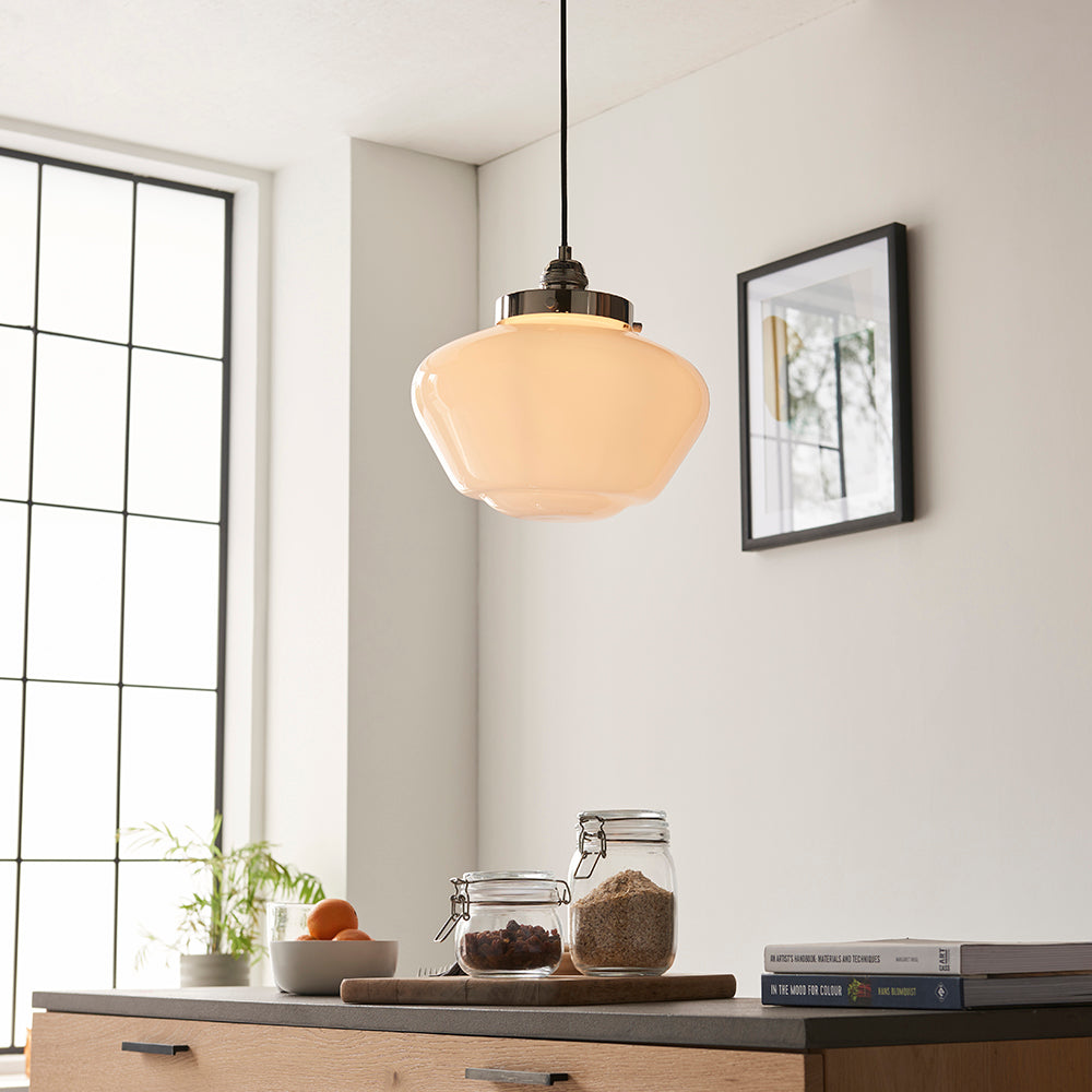 Endon Kedleston pendant light with rounded opal glass shade and polished nickel fitting, hung in a bright kitchen above a counter with jars and books.