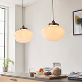 Endon Kedleston pendant lights in polished nickel with opal glass schoolhouse shades, hung as a pair above a kitchen worktop with jars and books.