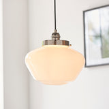 Endon Kedleston pendant light with rounded opal glass shade and polished nickel fitting on black flex, hung in a bright interior beside a framed picture.