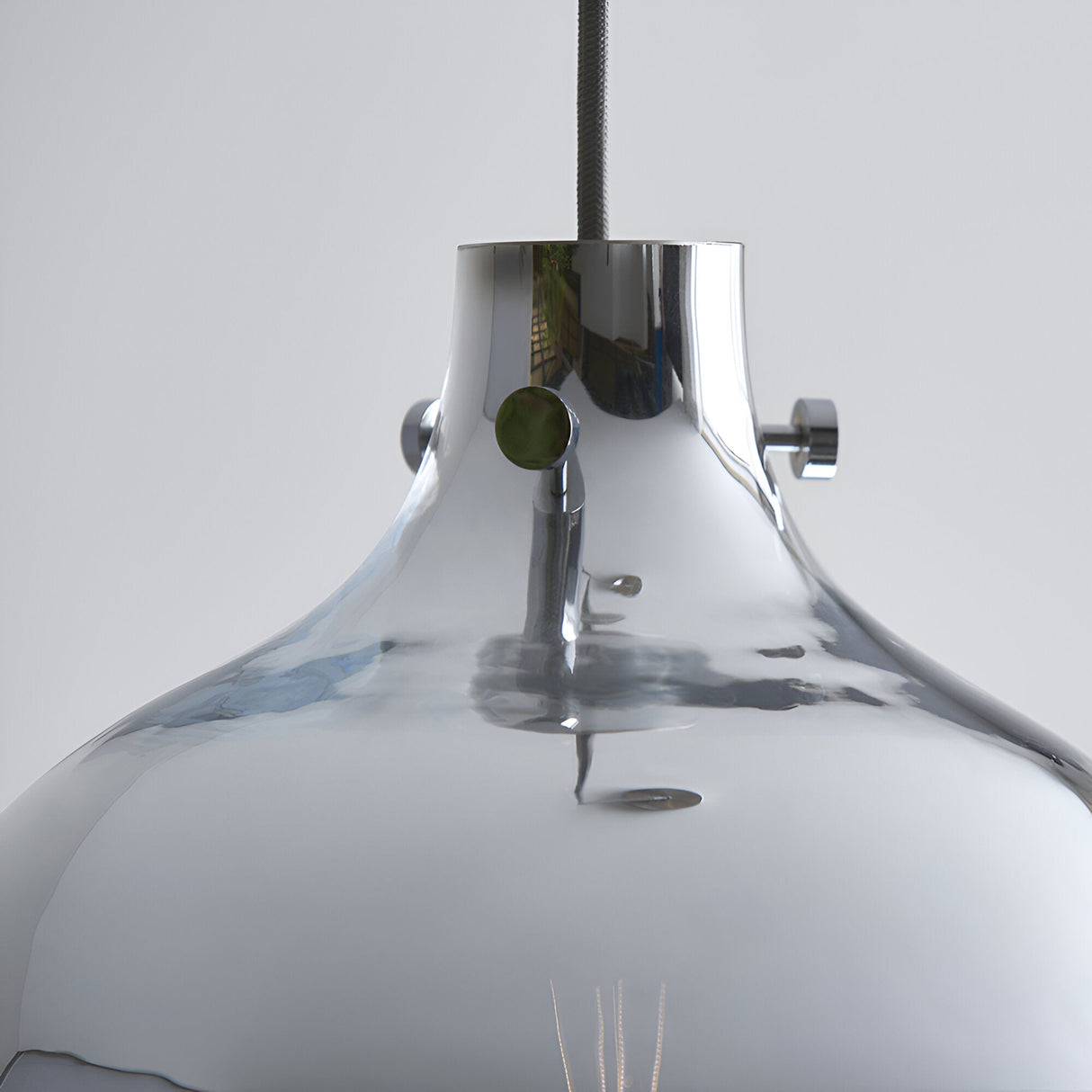 Close-up of the Castworth Glass Pendant in chrome, showing the domed glass shade, chrome fitting with screws, and grey fabric cable against a plain background.