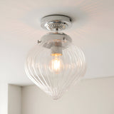 Endon Thornton flush bathroom ceiling light in chrome with a ribbed clear glass teardrop shade and single E27 lamp, mounted to a white ceiling.
